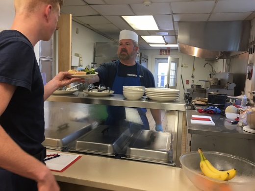 Tim Carroll serving food at station Manemsha