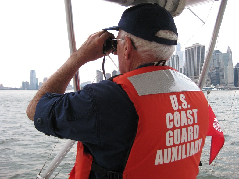 Auxiliarist Pat MacWalters on look out on a vessel on the Hudson River.