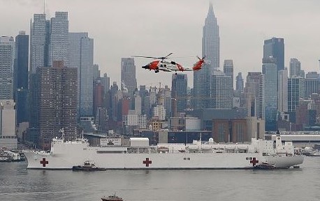 USNS Comfort enters New York - USCG helicopter top center
