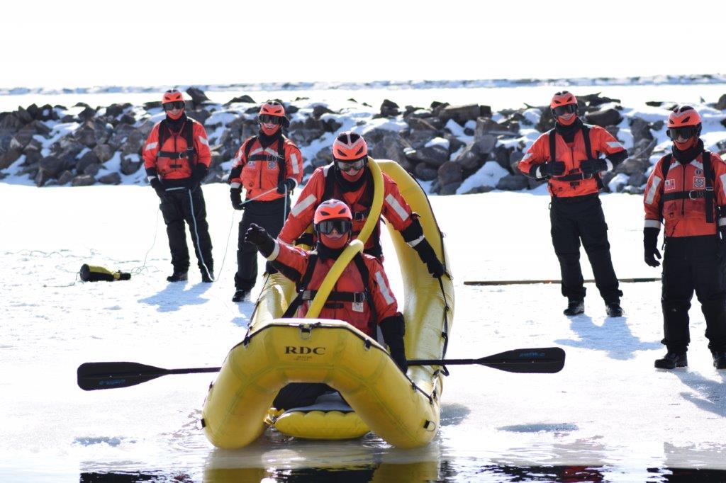 USCG members on raft preparing to enter water