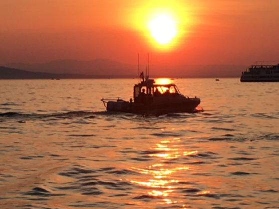 Division members on water patrol at sunset