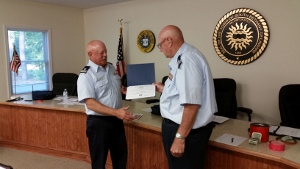 Dave Ritondo, at left, faces Fran Doyle as he receives his certificate
