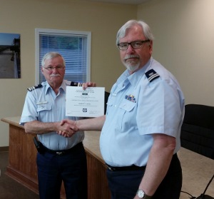 Bob Adams, at left, holds his certificate while shaking hands with Steve Straneva