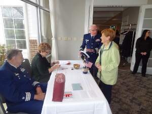 Bob and Kathy Lesperance are standing at the registration table 
