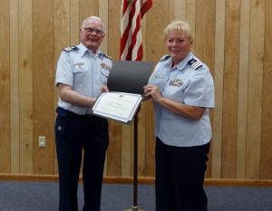 Bob Lesperance, standing at left, holds certificate along with Cindi Chaimowitz on right