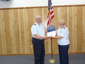 Steve Straneva, standing at left, holds his certificate along with Cindi Chaimowitz on the right