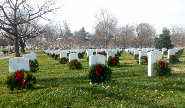 Rows of markers with wreaths and red bows on them as far as one can see.