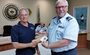 John Craig (at left) shakes hands with Steve Straneva as Steve holds his Auxiliary member ID