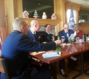 Three petty officers and the Division Commander are shown seated at the head table
