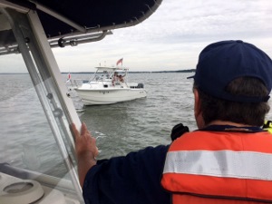 Doug Deiss, back to camera, sizes up the "dead in the water" boat on approaching its port side