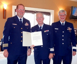 Bruce is standing between CDR Tim A. Gunter and Barry Kyper, DCO(E) as he holds his certificate