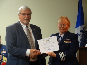 Steve, in business suit at left, receives a certificate from Cindy Chaimowitz