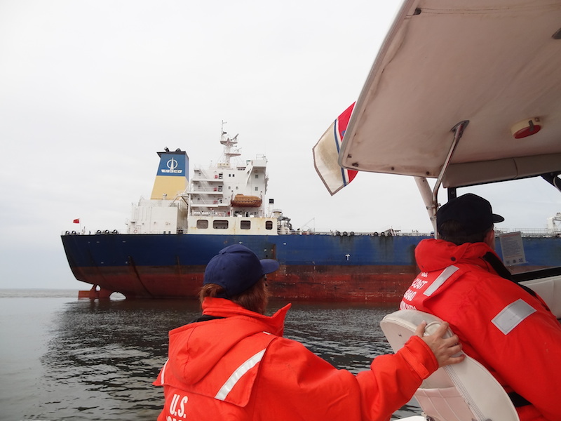 Members of 12-5 Boat Crew on Patrol in DE Bay looking at a Tanker Underway