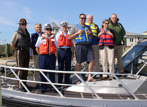 Left to right: Fish & Wildlife Natural Resources Police Chief Robert Legates, DNREC Division of Fish & Wildlife Director David Saveikis, Coast Guard Auxiliary Flotilla 12-02 FSO-MT Thomas Mann, Auxiliary Division 12 Commander Warren Huff, State Senator Ernest Lopez, State Representative Harvey Kenton, DNREC Deputy Secretary Kara Coats and State Representative Richard Collins.