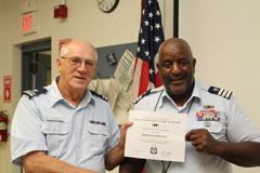 Earnest Stevenson (r) receives an award from Flotilla Vice-Commander Roy Zimmerman (l) for 15 years of participation in the U.S. Coast Guard Auxiliary.