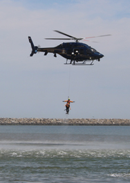 Delaware State Police demonstrate a helicopter water rescue. “Oscar” is hooked up so that the rescuer is not required to hold on to him (her) at all!