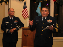 CGAux Flotilla Commander, Richard Stevenson (l) watches on as Coast Guard Station Chief, Jim Pond, (r) addresses the CG Auxiliary holiday party attendees. The Chief routinely makes himself and his crew available for training, education and support for Auxiliarists.