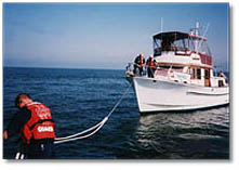 Picture of boat being towed by USCG AUX patrol vessel