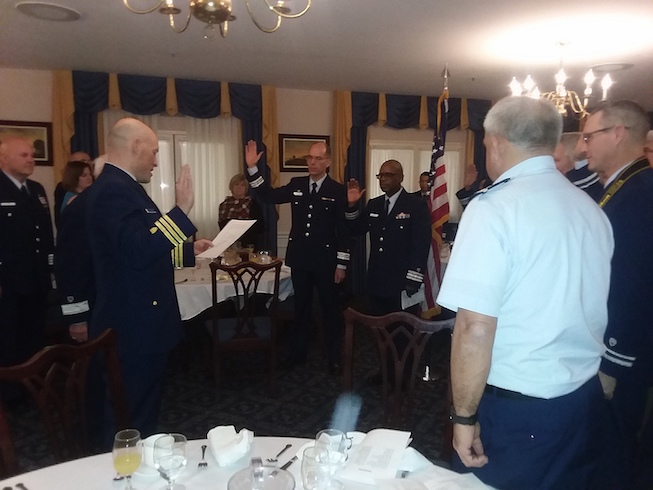 Commander Mike Batchelder swears in two officers of Division 25