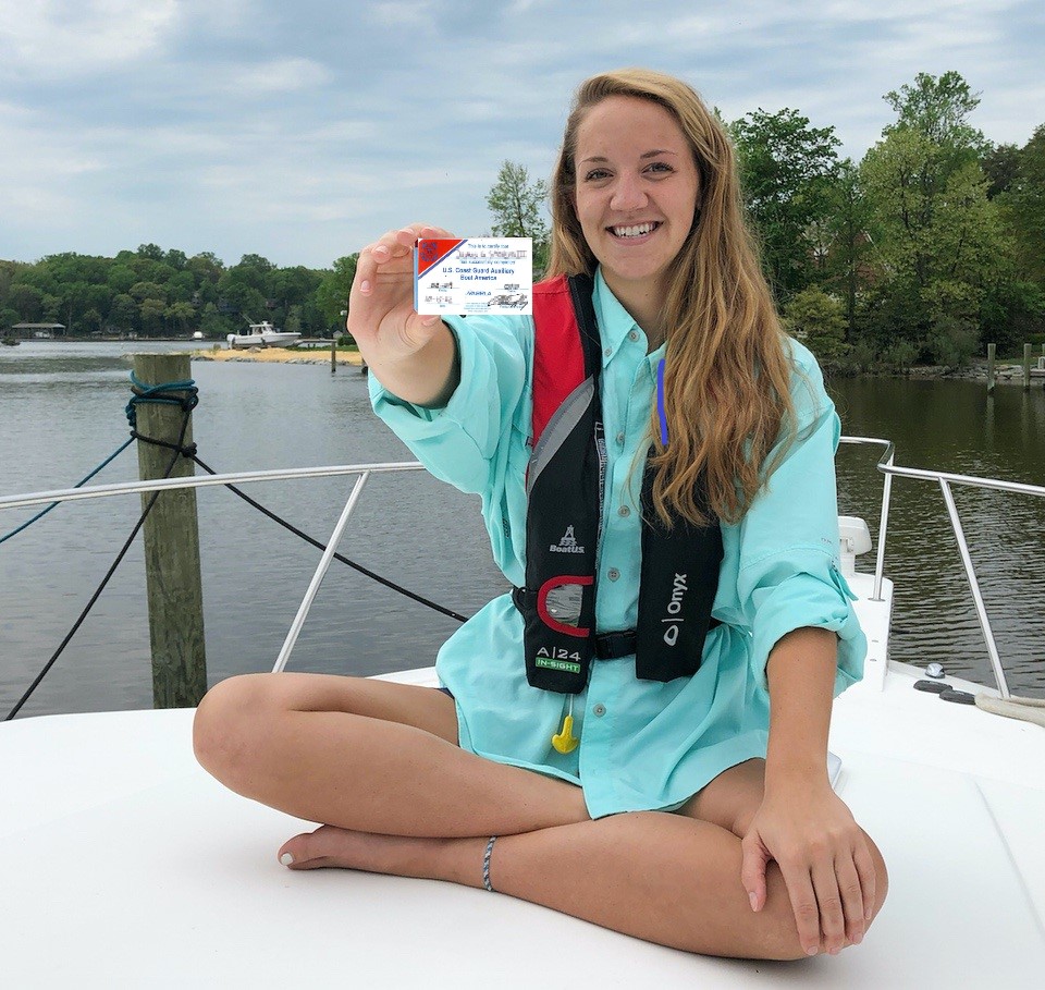 Young lady holding her boating safety card