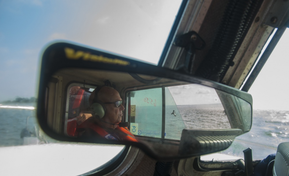 Image of Coast Guard Auxiliary member in mirror