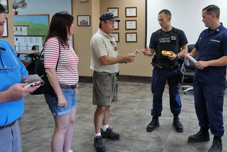 Coastguardsman explaing law enforcement equipment during Station Yankeetown Day April 2018