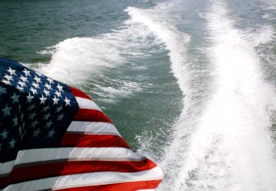 American Flag blowing in the wind off the stern of facility