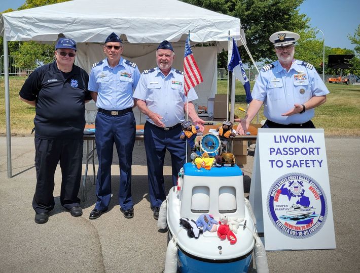 Flotilla 18-05 members (and friends) at the 2023 Livonia Passport to Safety program with Coastie.