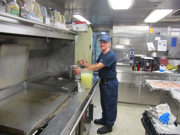 Auxiliarist cooking on USCG Cutter