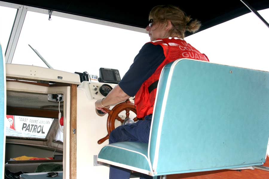 Coxswain Oltz taking turn at helm