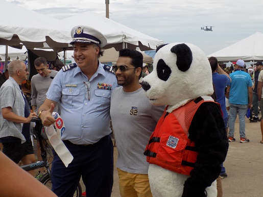 Officer and panda with plane in the background
