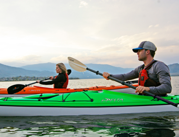 Picture of two kayakers paddling on a lake.