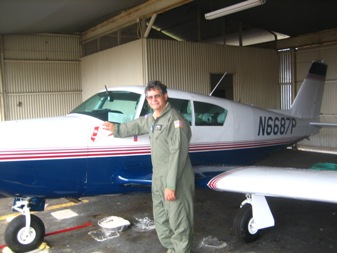 Mike beside his plane checking it out.