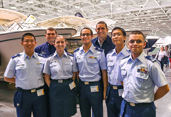 Group of auxiliarists in uniform pose at boat show