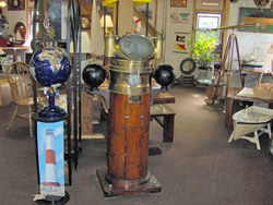 photo of a room with various ship equipment, including globes, portholes and telescopes