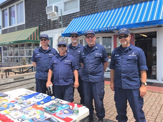 Flotilla members handing out safe boating material at harborfest