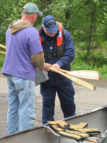 Charles Poltenson doing a Vessel Safety Check for a canoe race participant