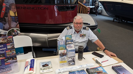A picture of Greg Barth manning the information table at Short's Marine.