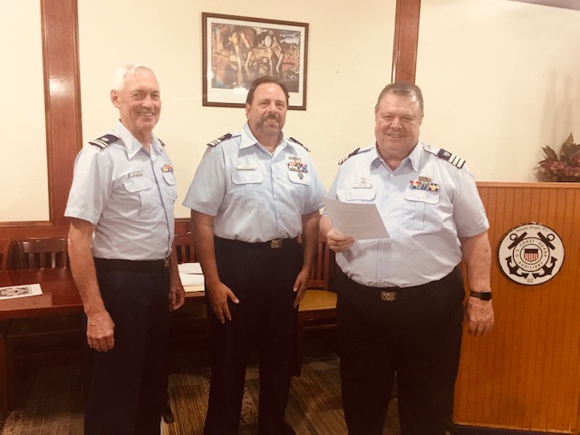 Division commander swearing in new flotilla commander and vice commander