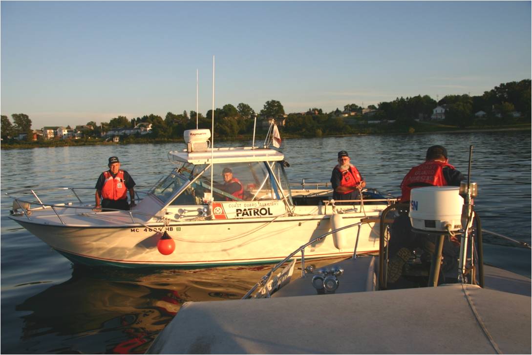 Several Men in Auxiliary Uniforms working together on two boats